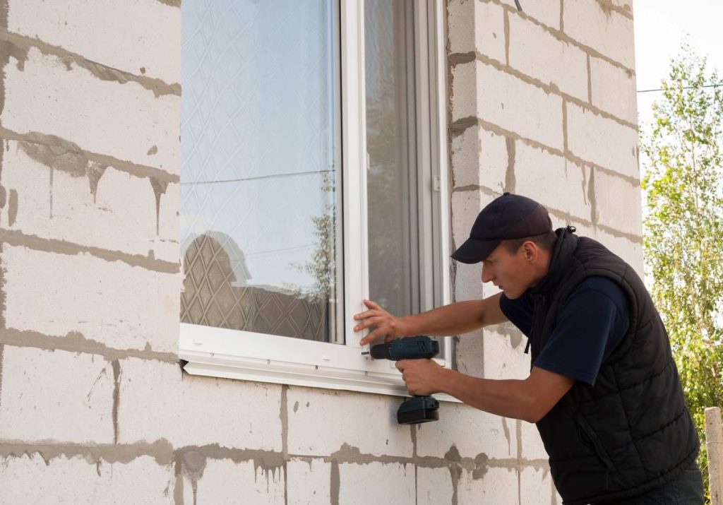 construction worker sets of metal and plastic window